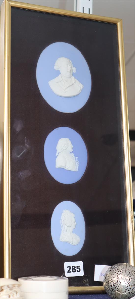 Three Jasper portrait plaques, framed as one.